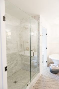 a bathroom with a walk in shower next to a bathtub and toilet bowl on the wall