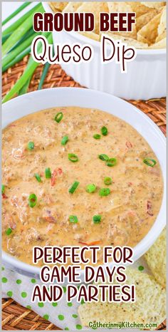 a bowl of queso dip with green onions and chips