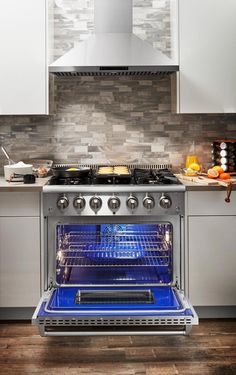 an oven with the door open in a kitchen