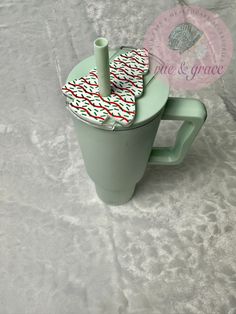 a green coffee cup with some napkins in it