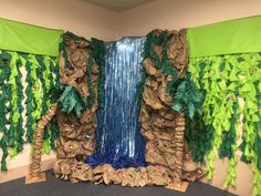 an office cubicle decorated with paper trees and waterfall