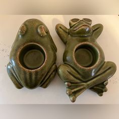 two green ceramic frogs sitting next to each other