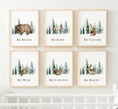 four framed pictures with animals on them in front of a white crib and wall