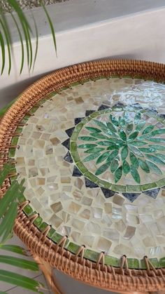 a wicker table with a mosaic design on it