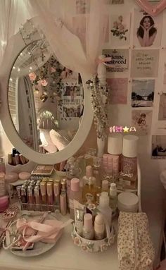 there is a vanity with lots of items on it and a large mirror above it