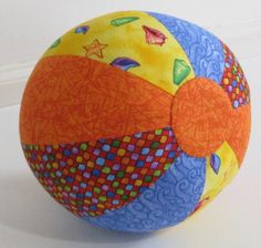 an orange and blue ball sitting on top of a table