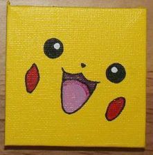 a close up of a painting on a wooden surface with a smiley face painted on it