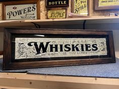 a wooden framed sign that says whiskies on the front and back of it