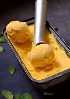 two scoops of ice cream in a metal container