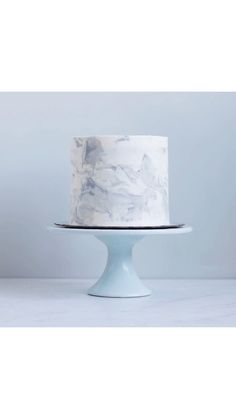 a marbled cake sitting on top of a white pedestal