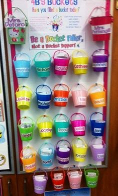 buckets are hanging on the wall in front of a vending machine