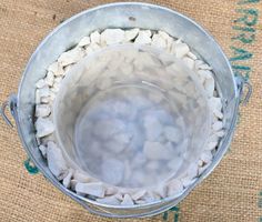 a metal bucket filled with rocks and water