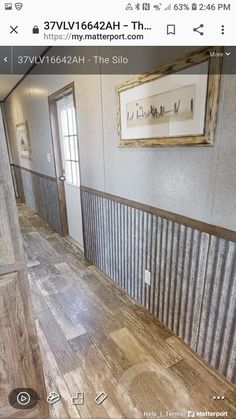 an image of the inside of a house with wood flooring and metal sidings