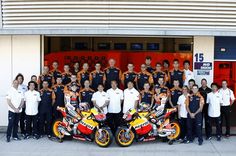 the motorcycle racing team is posing for a photo