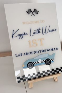 a welcome sign with a racing car on it