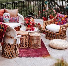 an outdoor patio with wicker furniture and flowers