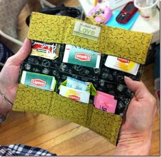 a person holding up a wallet that has several cards in it and some magnets on the inside