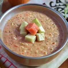 a bowl filled with soup sitting on top of a table