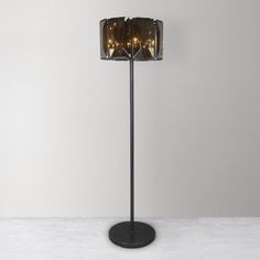 a black floor lamp with three lights on the top and one light on the bottom