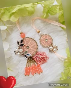 two necklaces with pearls and beads on a white furnishce background next to a red heart