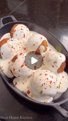 a pan filled with donuts covered in white icing