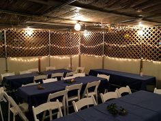 tables and chairs are set up with blue tablecloths for an indoor function venue