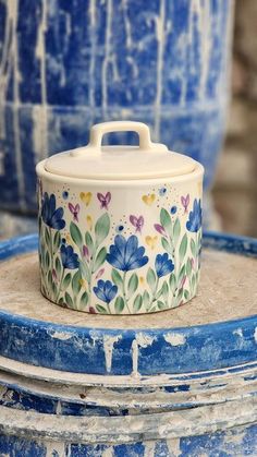 a blue and white pot sitting on top of a table