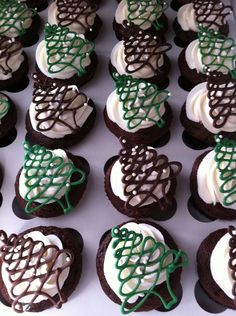 chocolate cookies decorated with white and green icing in the shape of heart shaped trees