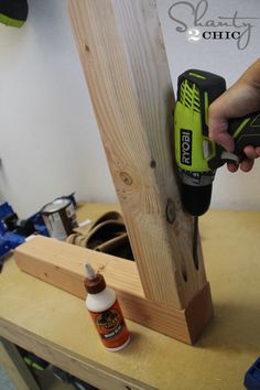 a person using a power drill to attach a piece of wood