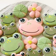 decorated cookies with frog faces and flowers on a plate