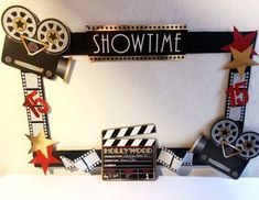 a sign that says show time with some films on the board and stars around it