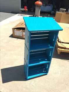 a blue shelf sitting on top of a cement floor