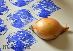 an onion sitting on top of a piece of paper with blue ink drawn on it