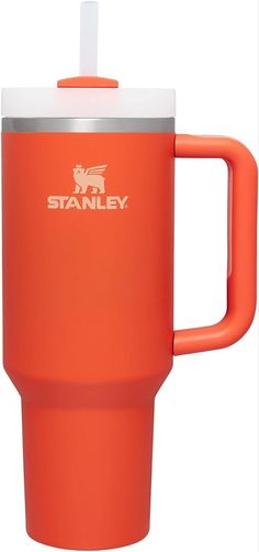 an orange travel mug with a white lid and handle is shown in front of a white background