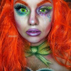 a woman with bright orange hair and green eyes is dressed up as the little mermaid