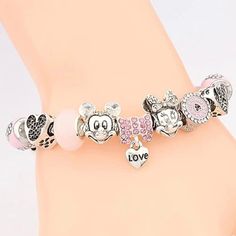 You can’t say you love Minnie Mouse if you don’t have one of these cute pink charm bracelets on your arm or in your jewelry box. These quality charms catch the light and steal the show in any room you enter. They are also removable which means that you can put them on another bracelet or jewelry piece and continue your slay. DIY your charm bracelet or mix and match, whatever the case create your very own unique style. Buy this bracelet to invest in your Disneyland drip or gift this luxury charm Cute Charm Bracelet With Removable Charms As Gift, Trendy Pink Bracelets With Charms, Trendy Pink Charm Bracelets, Pink Novelty Bracelets With Charms, Pink Charms Bracelets Novelty Style, Trendy Pink Friendship Charm Bracelet, Trendy Pink Heart-shaped Charm Bracelet, Trendy Pink Charms As A Gift, Trendy Pink Charms For Gift