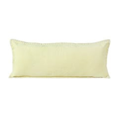 a yellow pillow on a white background