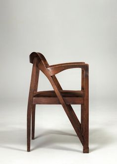 a wooden chair sitting on top of a white floor