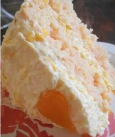 a piece of cake sitting on top of a pink and white plate with orange icing