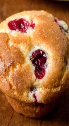 two blueberry muffins sitting on top of a wooden table