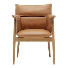 a tan leather chair with wooden legs and armrests, on a white background