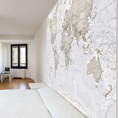 a bedroom with a large map on the wall