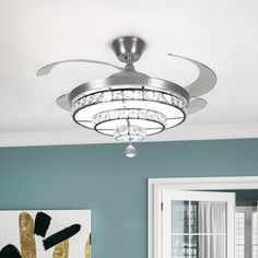 a living room with white walls and a ceiling fan in the middle of the room