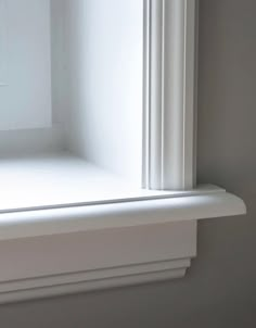 an open window with white trim in a room