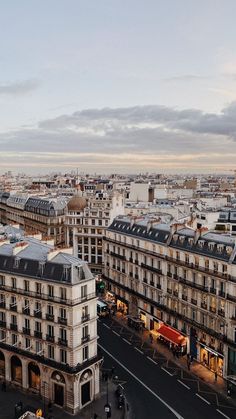 an aerial view of the city with buildings and cars on it's sides,