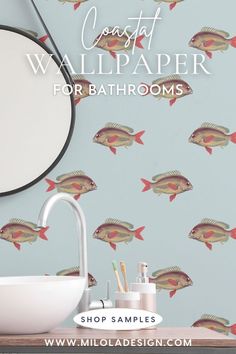 Bathroom interior of sink and bathroom accessories with a blue fish patterned wallpaper and round mirror. Bathroom Wallpapers, Modern Coastal Bathroom