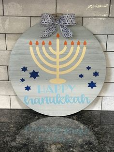 a happy hanukkah sign hanging on the wall