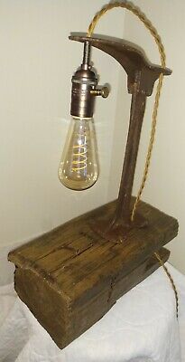 an old fashioned lamp is sitting on top of a wooden box