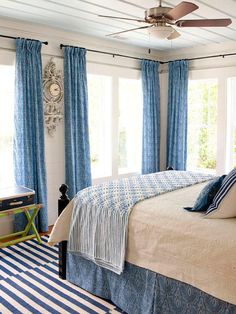 a bedroom with blue and white striped rugs