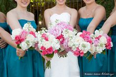 the bridesmaids are holding their bouquets together